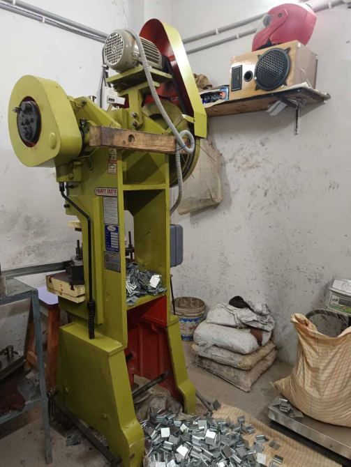 Power press machine producing sheet-metal components on the workshop floor